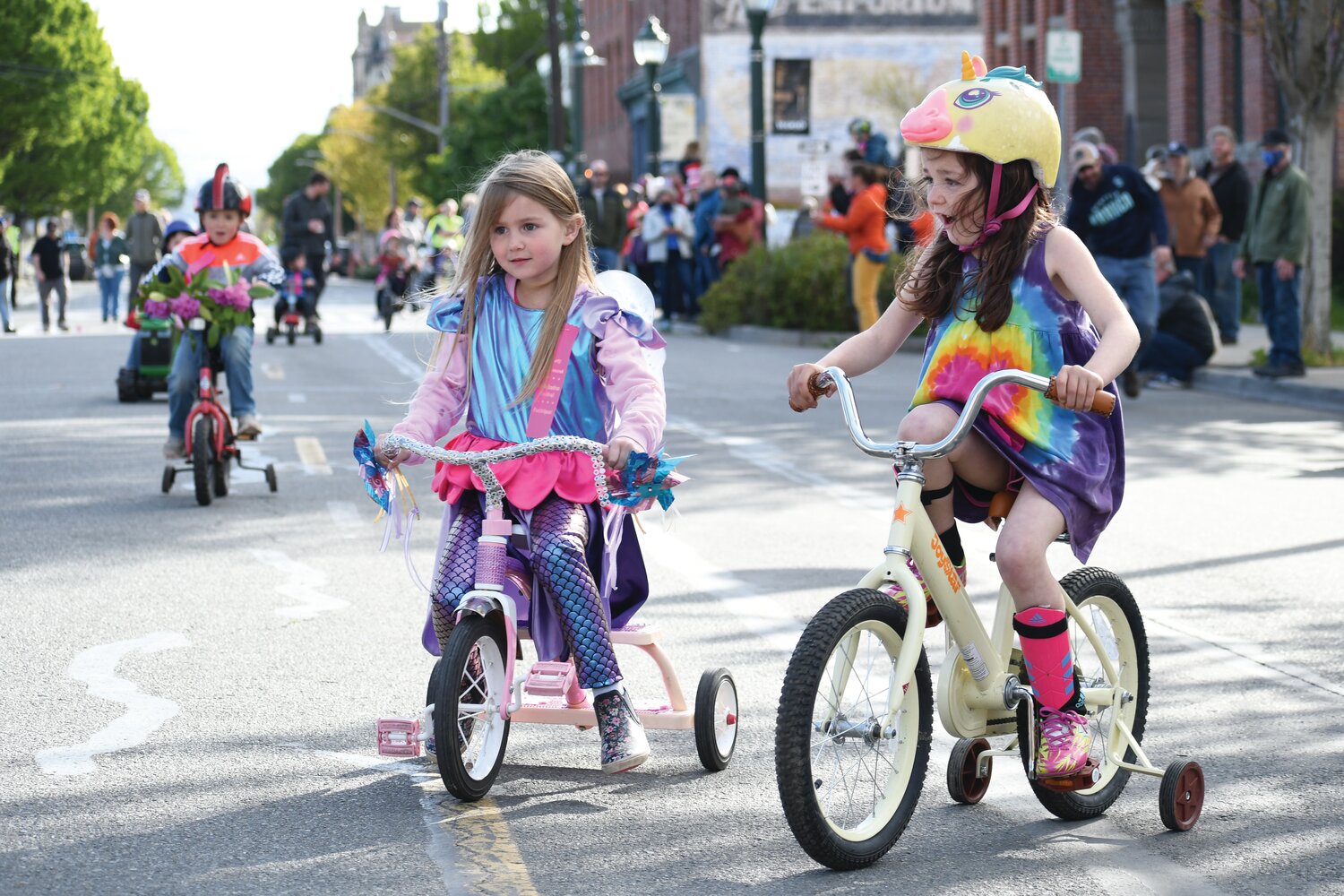Two youngsters at last year’s Rhody Trike Race stop to chit chat following the race.